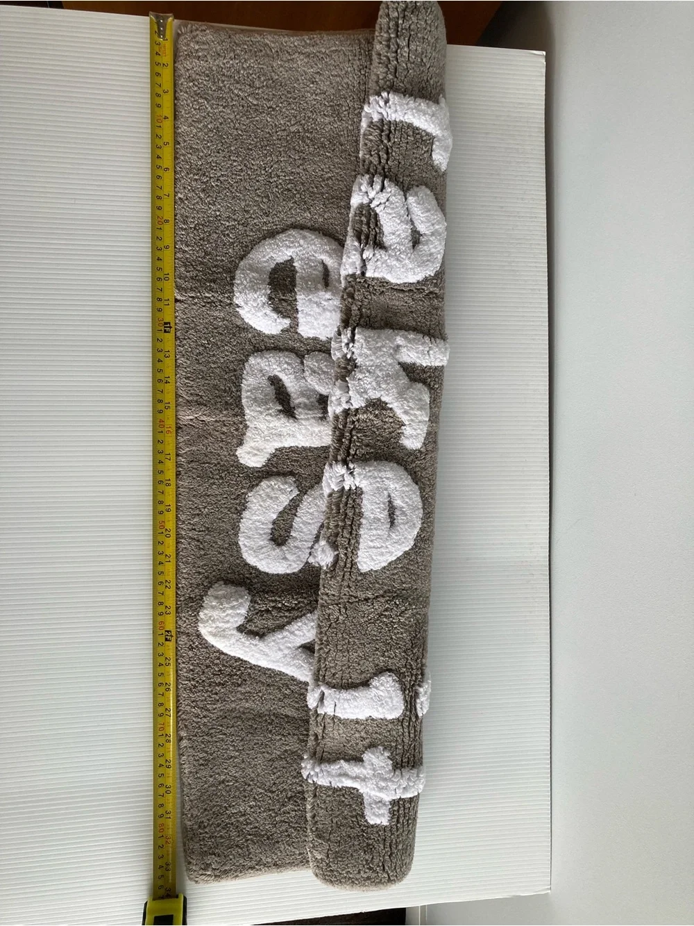 Taupe Bath Rug with White Raised 'take it easy' Text